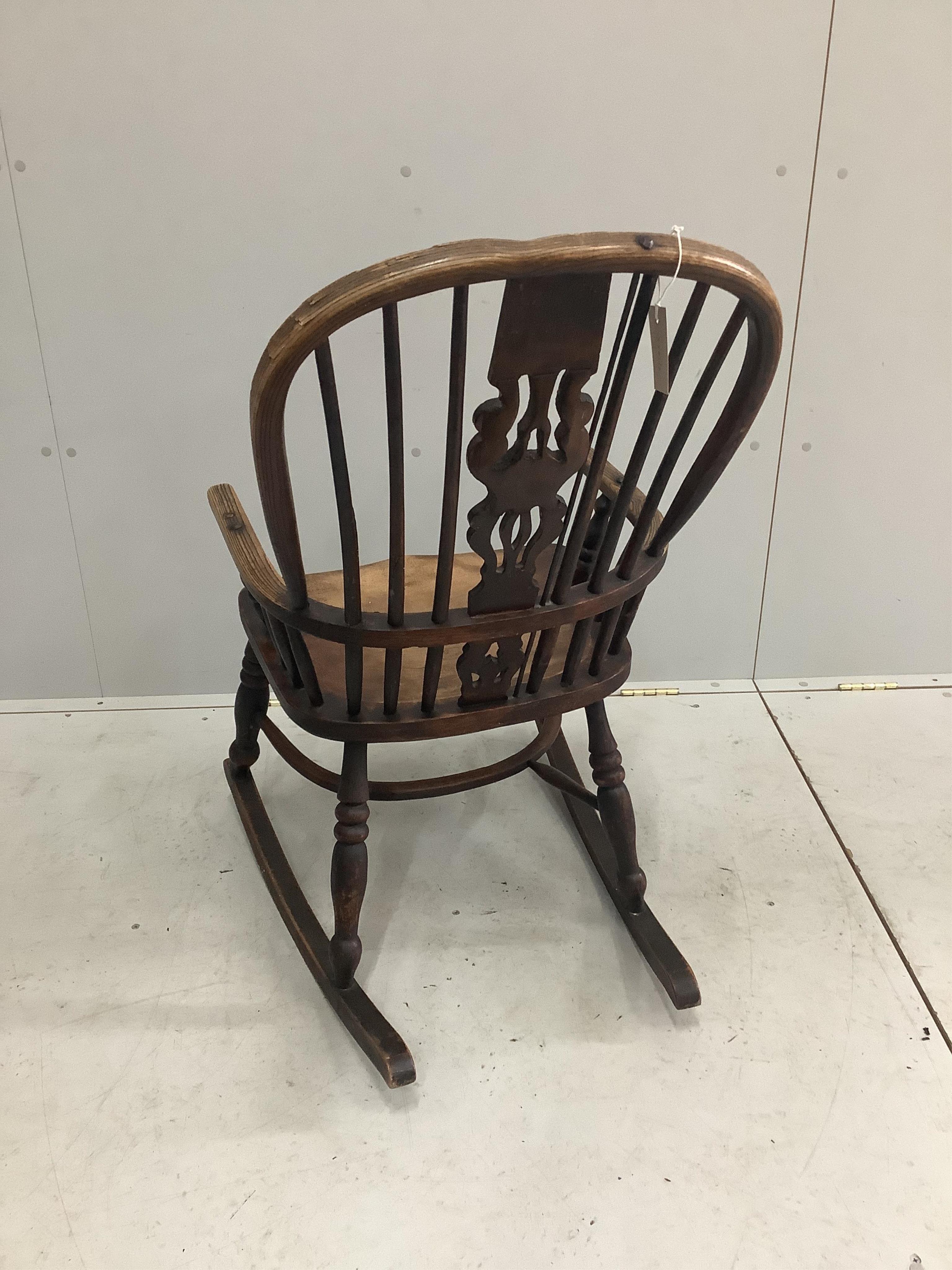 A 19th century ash, elm and beech Windsor rocking chair, width 53cm, depth 38cm, height 96cm. Condition - poor